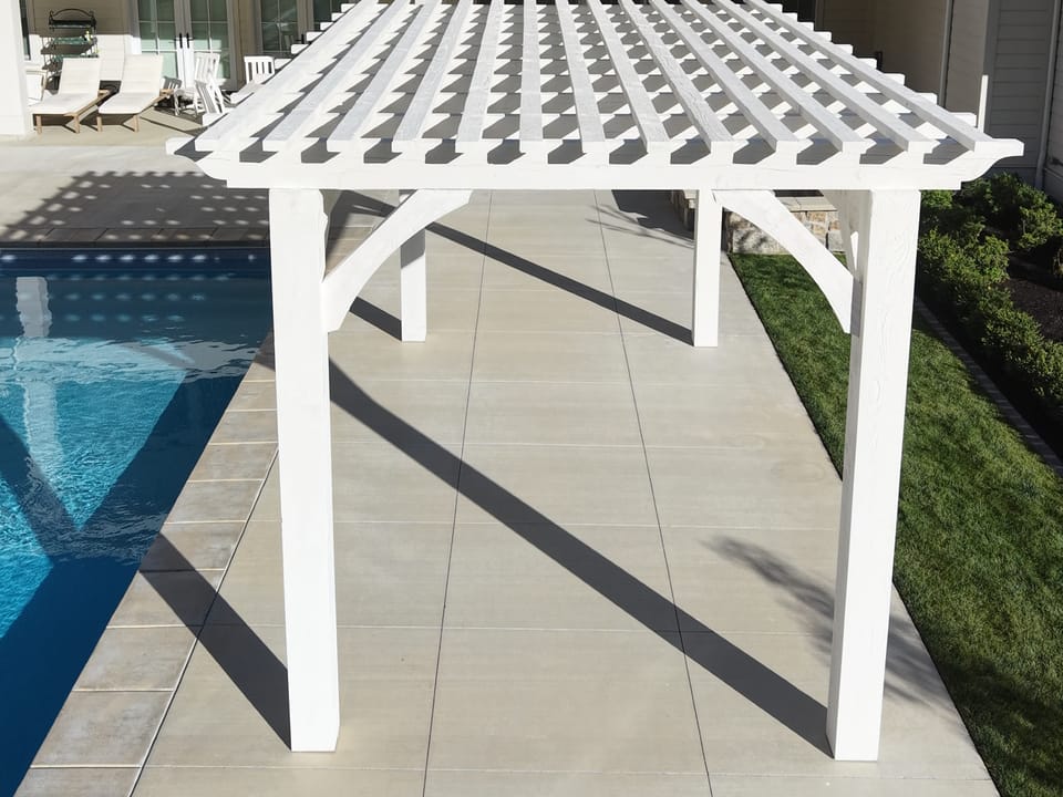 The finished Pinto White 12×20 pergola beside the pool in Alpine, Utah