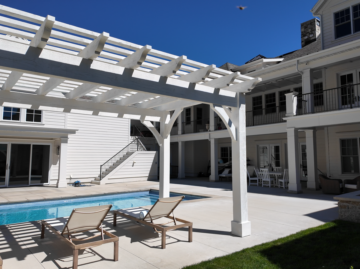 Pinto White 12×20 timber pergola shading loungers beside the pool in Alpine, Utah