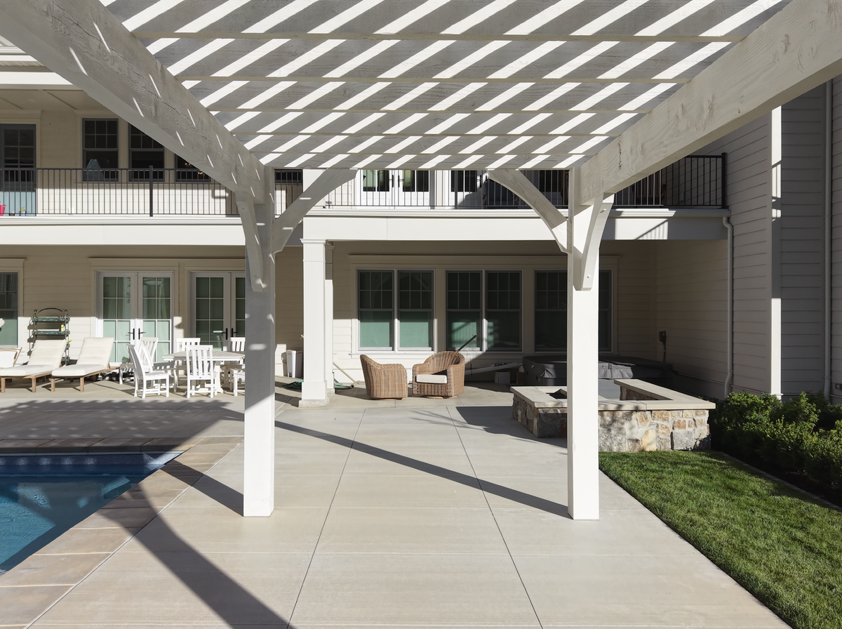 Looking out from under the Pinto White pergola's lattice toward the house in Alpine, Utah